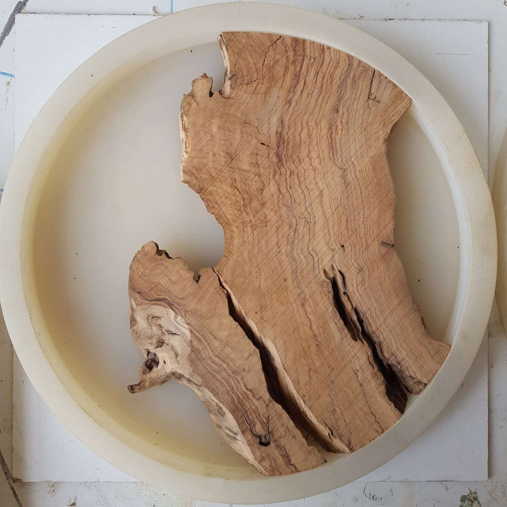 Empty silicone mold with olive wood piece in it