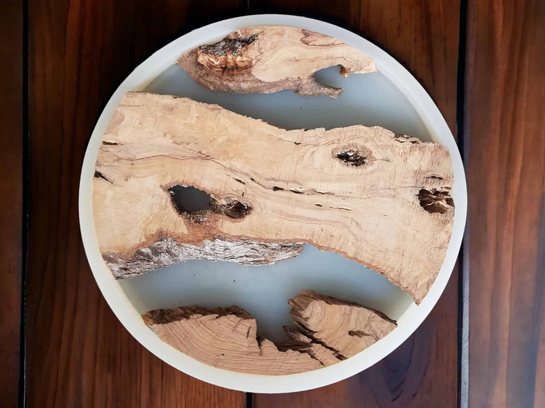 Circle shaped silicone mold and olive wood pieces inside