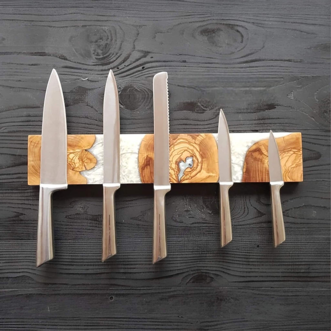 White resin and olive wood magnetic knife holder holding 5 knives