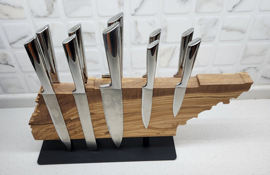 Set of knives in a wooden holder shaped like the state of Texas on a white background