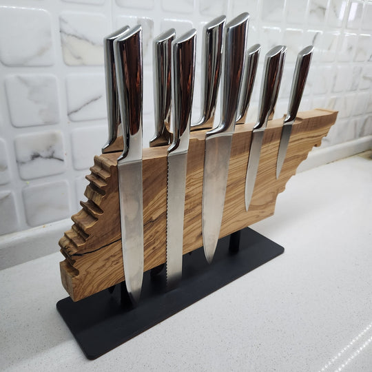 Set of knives in a wooden stand on a kitchen counter