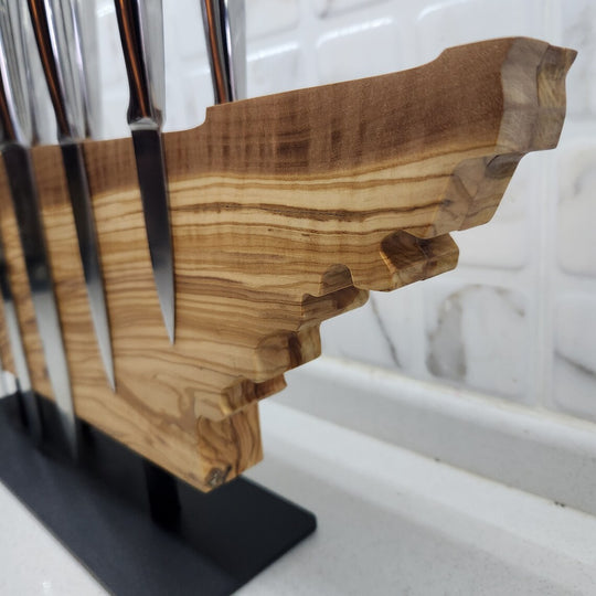 Wooden knife block with knives on a marble surface